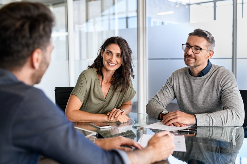 adult couple talking with agent