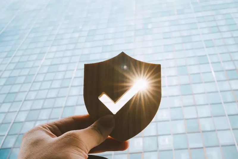 shield icon in front of building