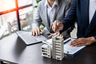 going over insurance documents with building model