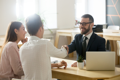 smiling agent assisting couple