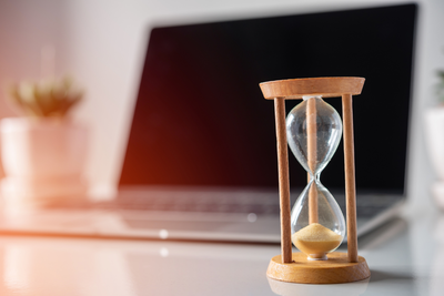 hourglass in front of computer