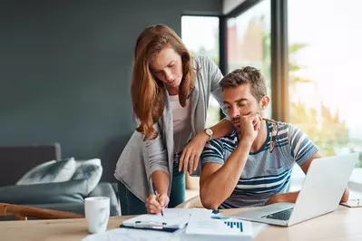 couple looking at high bills