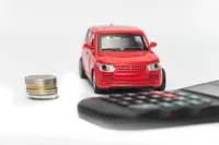 car with coins and calculator