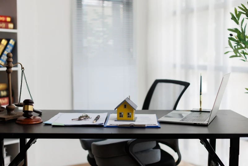 model home on desk by computer