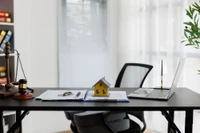 model home on desk by computer
