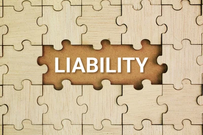 wooden puzzle with word "liability"
