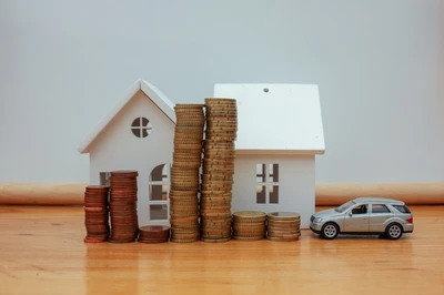 model houses and car with coins