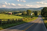 Two-lane country road curving past green pastures and a wooden fence toward wooded Tennessee hills, no people, logos, or text